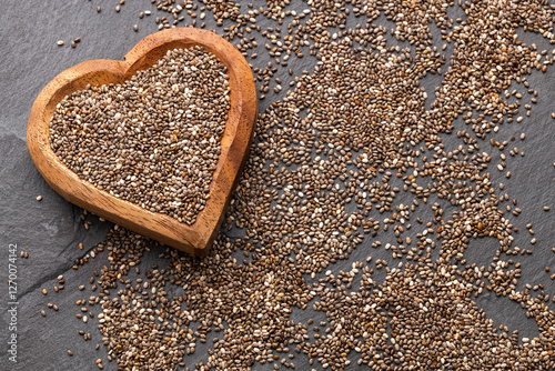 Salvia hispanica - Nutritious chia seeds in a heart shaped bowl. photo