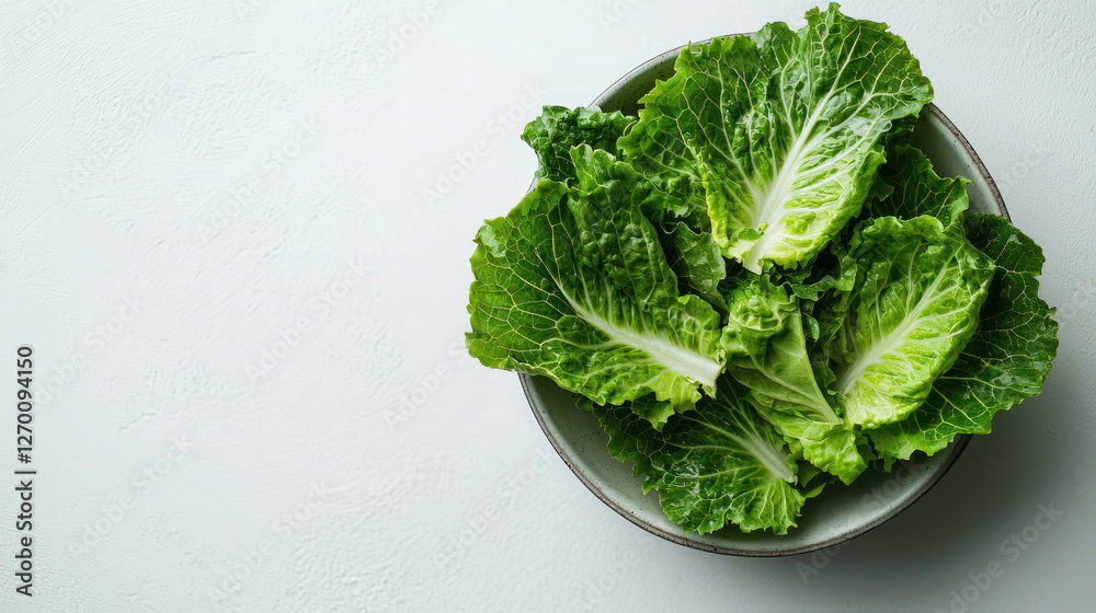 A Fresh lettuce leaves arranged in bowl on clean white surface, perfect for modern aesthetic with space for branding A Fresh lettuce leaves arranged in bowl on clean white surface, perfect for modern aesthetic with space for branding
