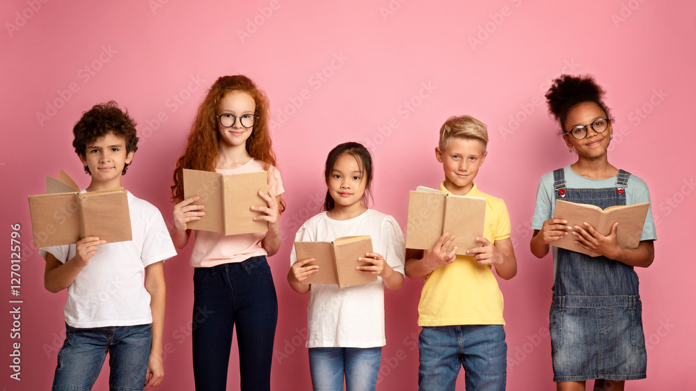 Group of adorable schoolchildren with textbooks posing on pink studio background Group of adorable schoolchildren with textbooks posing on pink studio background