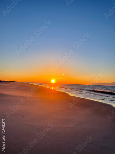 Gorgeous Orange Sunrise on cloudless sky with beach amd sea view in Long Island NY, America - concept of Nature, Beauty, Natural, 