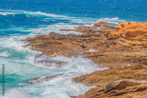 Afternoon sea breeze with choppy seas and earthy rocky headland photo