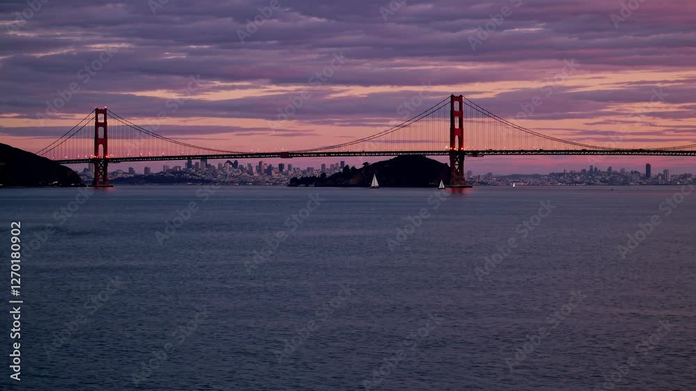 A wide-angle video captures the Golden Gate Bridge at sunset, showcasing the serene water and vibrant sky, creating a tranquil atmosphere. A wide-angle video captures the Golden Gate Bridge at sunset, showcasing the serene water and vibrant sky, creating a tranquil atmosphere.