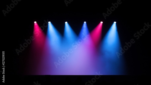 Stage lighting with pink and blue spotlights on a dark background.
