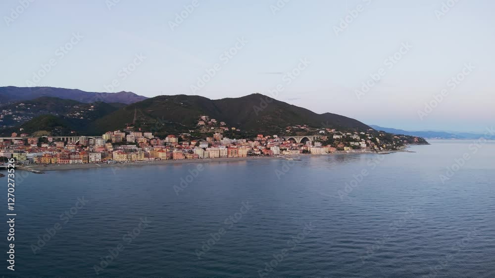 Trucking aerial shot of Varazze, Italy, showcasing the coastal town, colorful buildings, and serene seascape Trucking aerial shot of Varazze, Italy, showcasing the coastal town, colorful buildings, and serene seascape