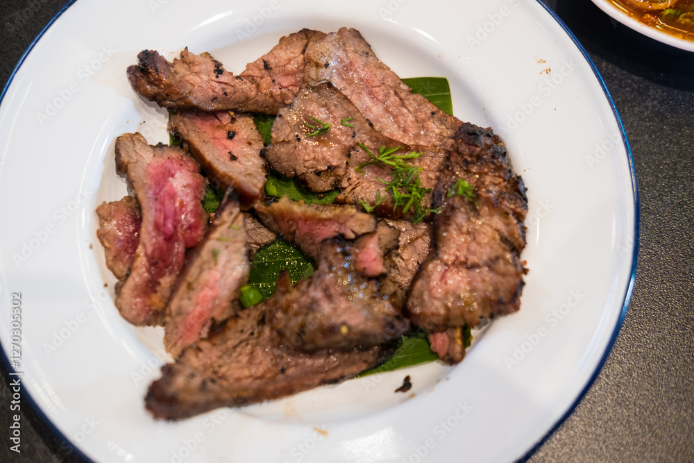 Thai slice of juicy grilled beef. Thai food style for eating with Somtum. Thai grilled beef brisket Thai slice of juicy grilled beef. Thai food style for eating with Somtum. Thai grilled beef brisket