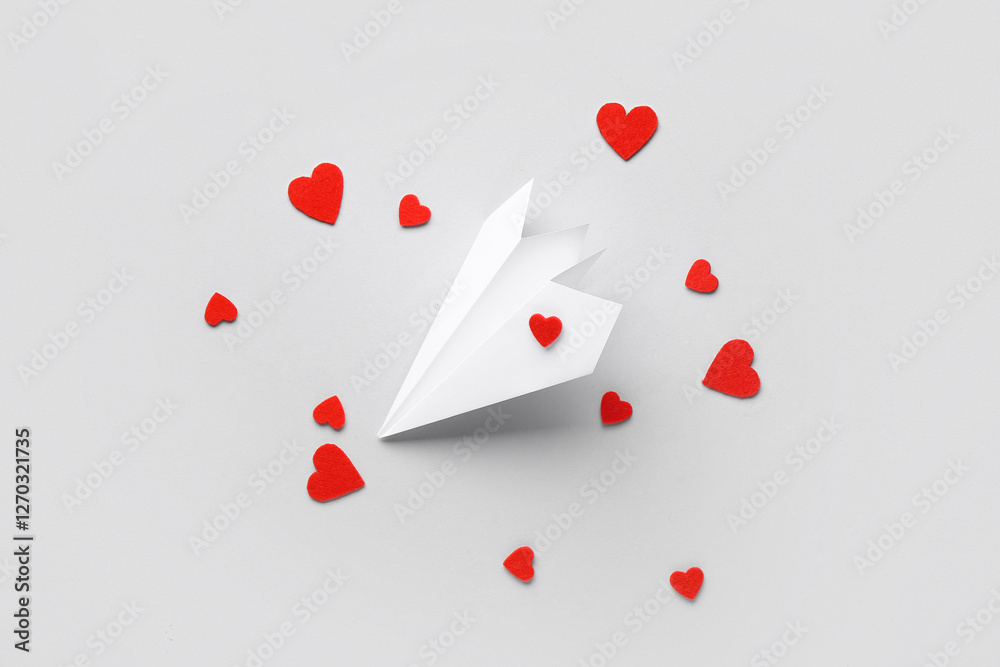 Paper airplane with red hearts on white background. Valentine's Day celebration Paper airplane with red hearts on white background. Valentine's Day celebration