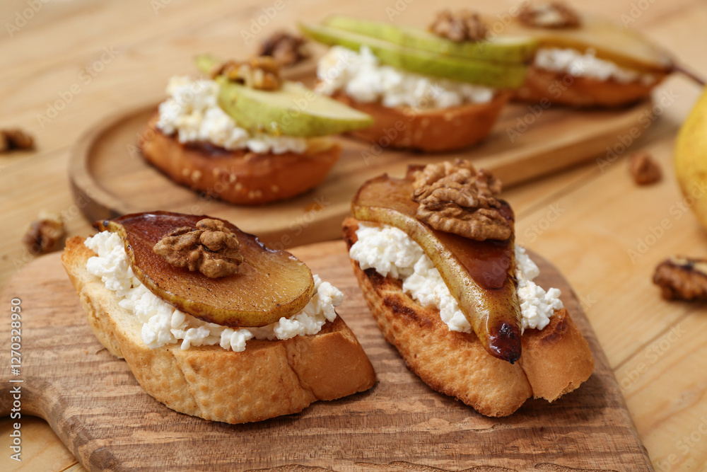 Boards of pear bruschetta with ricotta cheese and walnuts on wooden background, closeup Boards of pear bruschetta with ricotta cheese and walnuts on wooden background, closeup