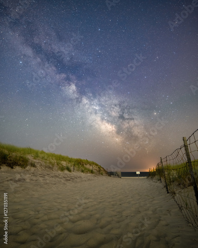 Milky way galactic core stretching over a sandy pathway down to the beach. Robert Moses State Park, New York 