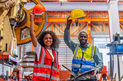 African workers working team happy aftter working of maintenance machine in heavy industrial factory