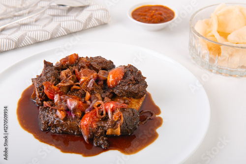 Indonesian sweet soy sauce grilled ribs, or Iga Bakar manis, cooked with chopped shallots and tomatoes
 photo