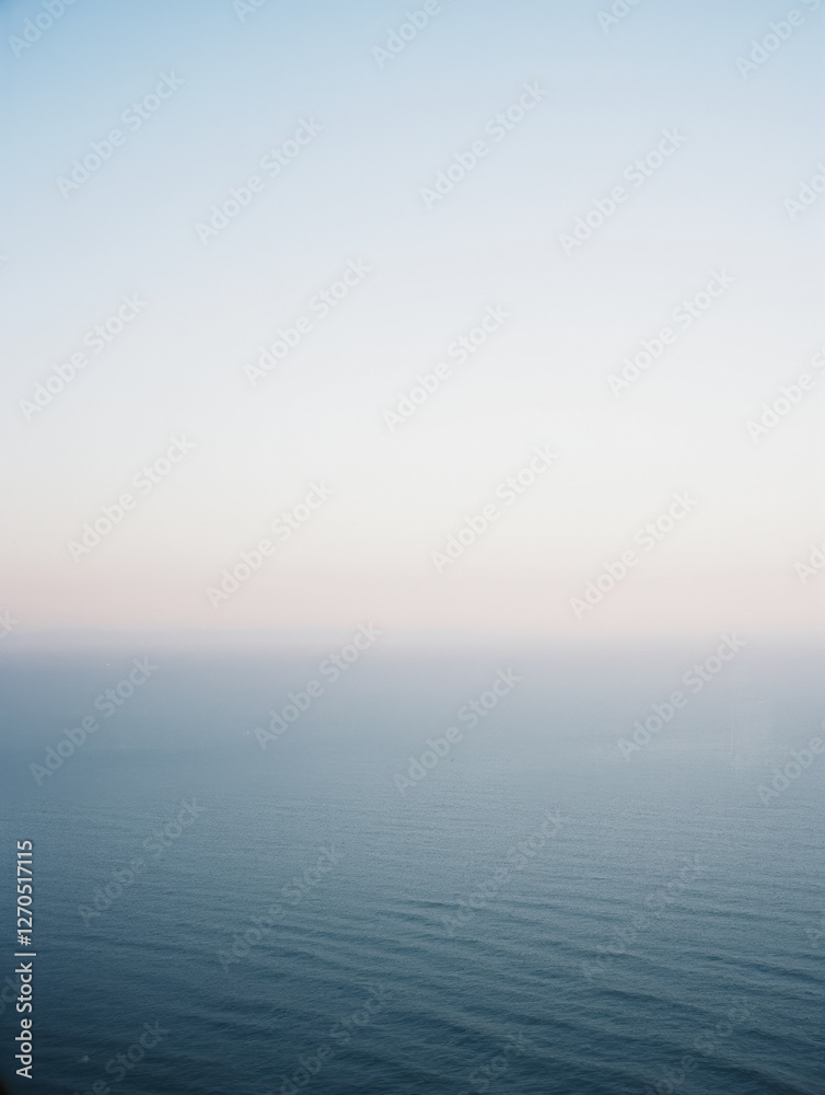 Calm ocean horizon under clear blue sky at dawn Calm ocean horizon under clear blue sky at dawn