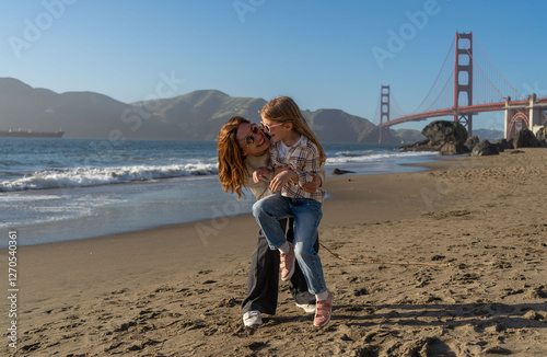 Canvas Print Mother and daughter have fun at the beach, focus on woman