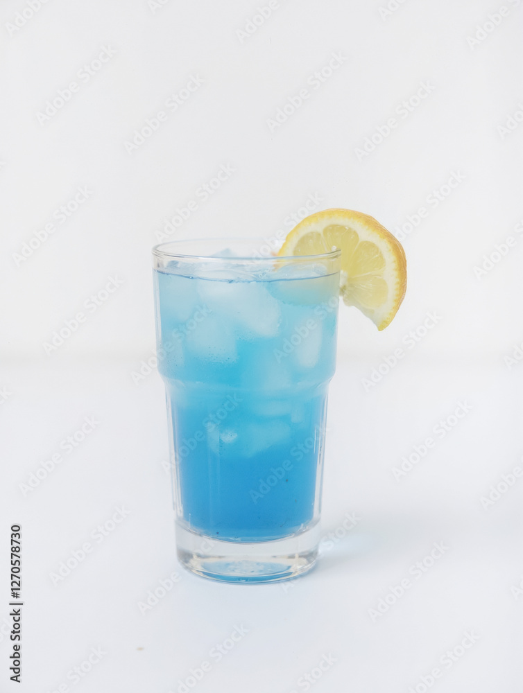 Refreshing blue lemonade with ice and lemon slice on a clear glass Refreshing blue lemonade with ice and lemon slice on a clear glass