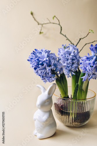 Hyacinth flowers in a glass vase on a beige background. Springtime Easter overhead banner with copy-space.