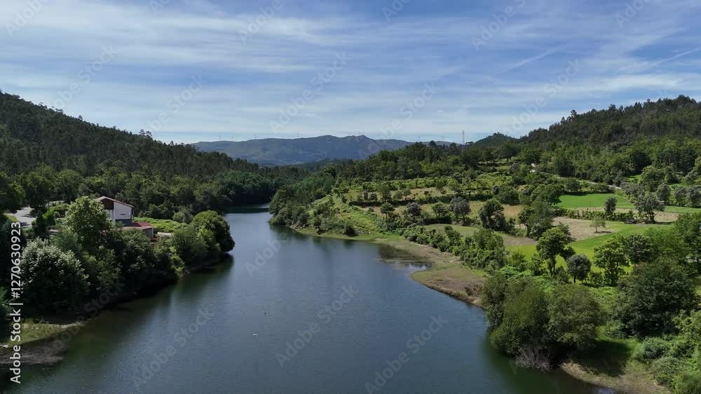 Aerial - Ave River flowing through green hills in Vieira do Minho, Portugal Aerial - Ave River flowing through green hills in Vieira do Minho, Portugal