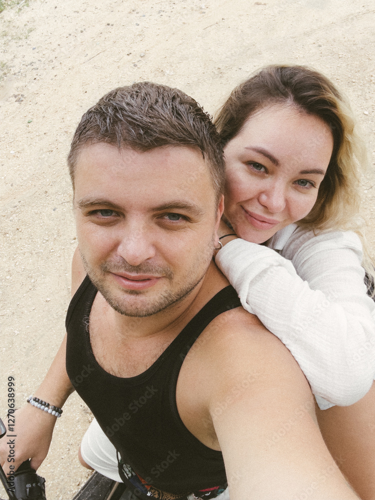 Fototapeta premium Young adult couple is taking a selfie on a scooter