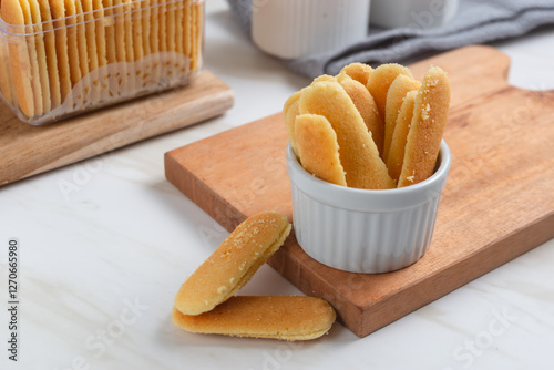 Kue lidah kucing or cat's tongue cookies. Traditional cookies for eid holiday in Indonesia. Perfect for recipe, article, catalogue, or any commercial purposes.