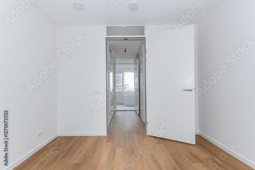 interior unfurnished empty basic stairway corridor landing to bathroom in modern new build residential smart house. Glass window view. Plain white walls and wood effect vinyl flooring blank canvas