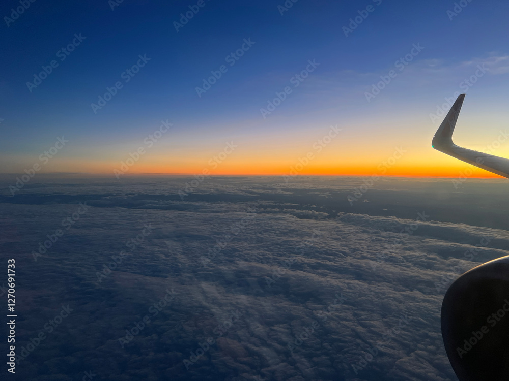 Sunset flight above the clouds