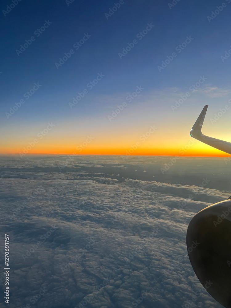 Sunset flight above the clouds