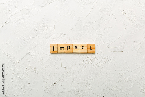 impact word written on wood block. impact text on table, concept