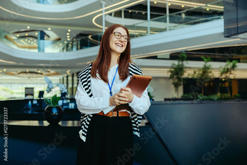 Successful professional woman in a large corporate office lobby