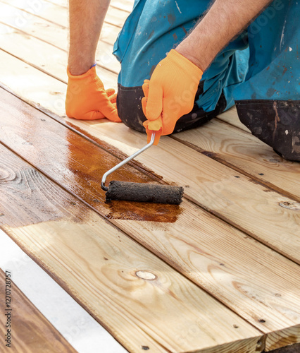 Wallpaper Mural Man is painting a wooden floor with a roller Torontodigital.ca