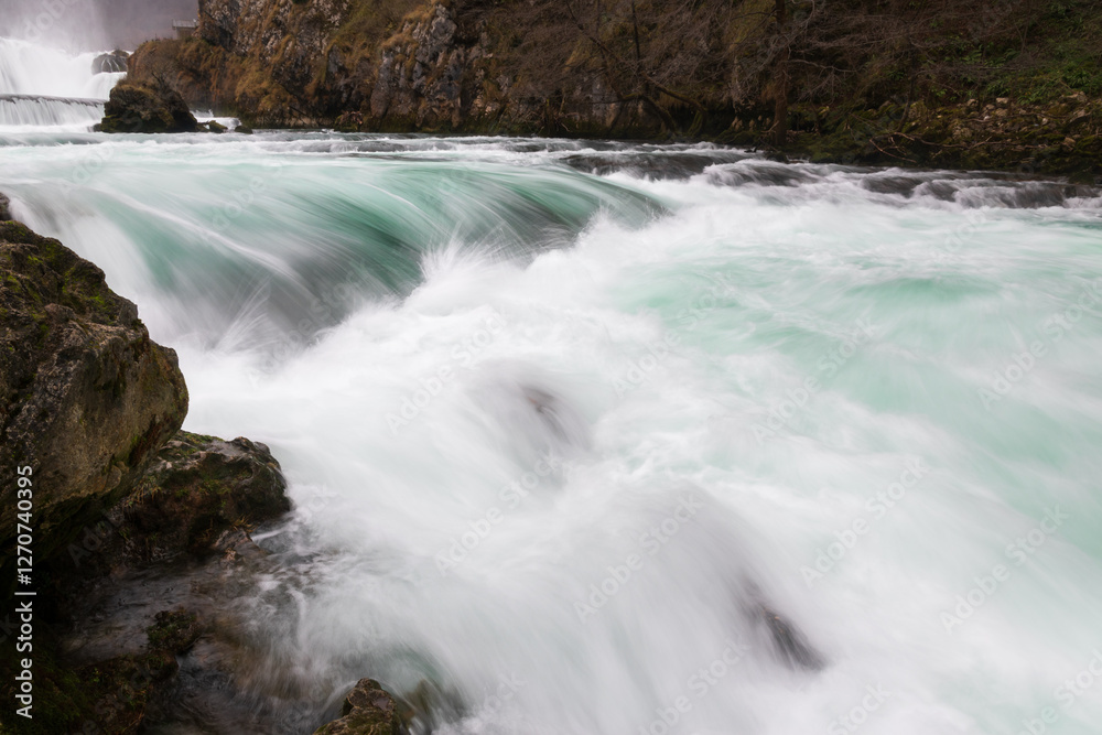 Obraz premium Waterfall and cascade on Una river, water sprays and flows in motion blur, turquoise colour