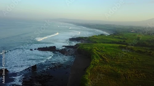 Wallpaper Mural Showcases the rugged cliffs meeting the vast ocean, bathed in the warm light of sunset. A breathtaking scene of Bali's natural beauty. Torontodigital.ca