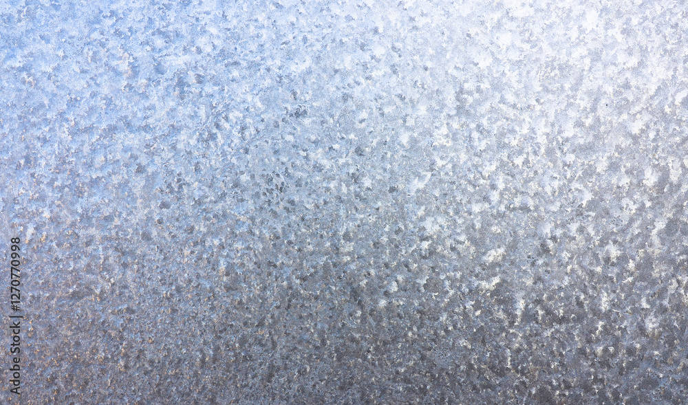 Obraz premium Ice crystals in detail on the window pane in winter. Abstract background of frosty water on the window glass. Texture of frosty patterns.
