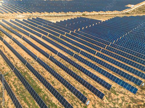 Aerial shot of photovoltaic panels in Teruel, Spain, arranged in structured rows. Clean energy generation supporting climate change solutions. photo