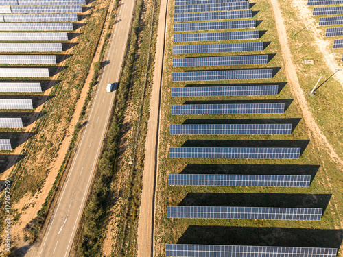 Aerial view of a solar farm in Teruel, Spain, with rows of photovoltaic panels generating renewable energy. Sustainable infrastructure for green power. photo