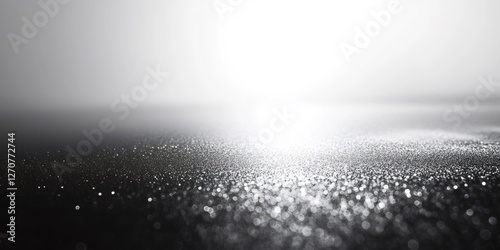 Silver glitter texture creating a sparkling bokeh effect with a gradient background