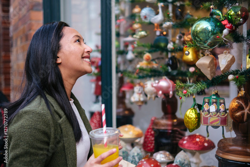 Happy woman shopping Christmas decoration at market photo