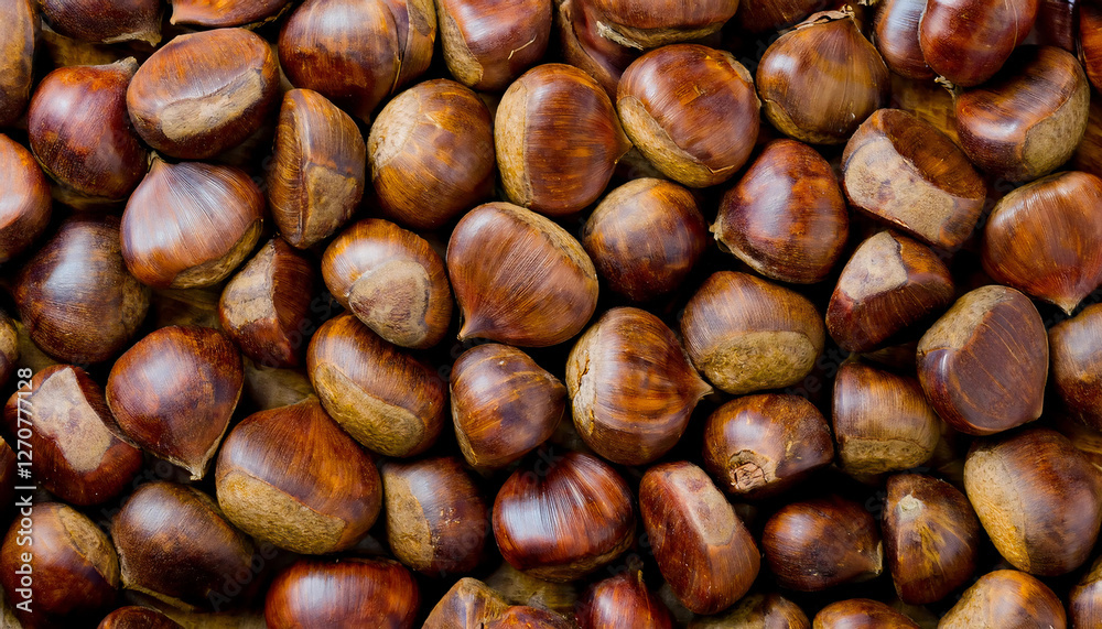 Background featuring chestnuts texture, showcasing their rough surface and warm brown tones. Ideal for autumn, baking, or natural food concepts. Texture, background. Background featuring chestnuts texture, showcasing their rough surface and warm brown tones. Ideal for autumn, baking, or natural food concepts. Texture, background.