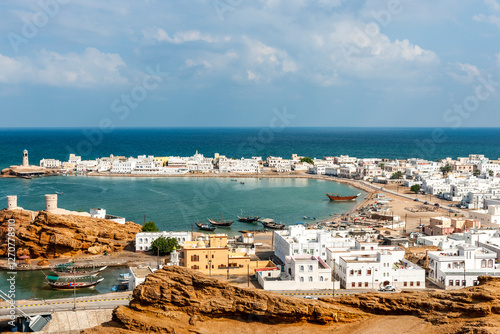 Scenic view of Sur harbor with traditional dhows in Oman photo