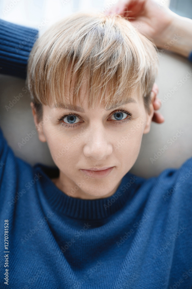 Portrait of a woman with blue eyes and short hair indoors Portrait of a woman with blue eyes and short hair indoors