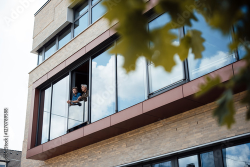 Engineers enjoying fresh air at office window photo