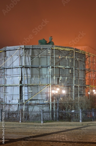 Sculpture protected by scaffolding at night in Kyiv, Ukraine photo