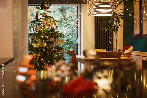 Decorated Christmas tree in kitchen at home photo