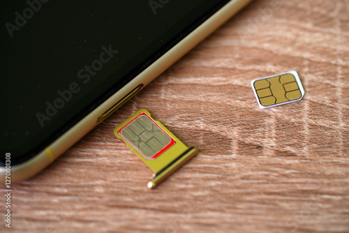 Set of color SIM cards near modern mobile phone background