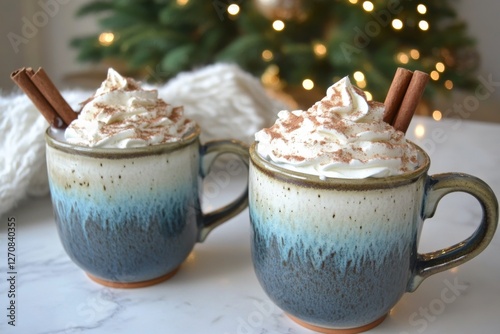 Warm cups of hot chocolate topped with whipped cream and cinnamon sticks duri...