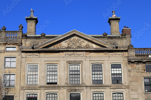 Amsterdam Keizersgracht Canal Building Facade Detail with Chimneys and Blue Sky, Netherlands photo