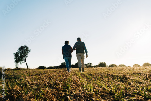 Two farmers walking and discussing in their field