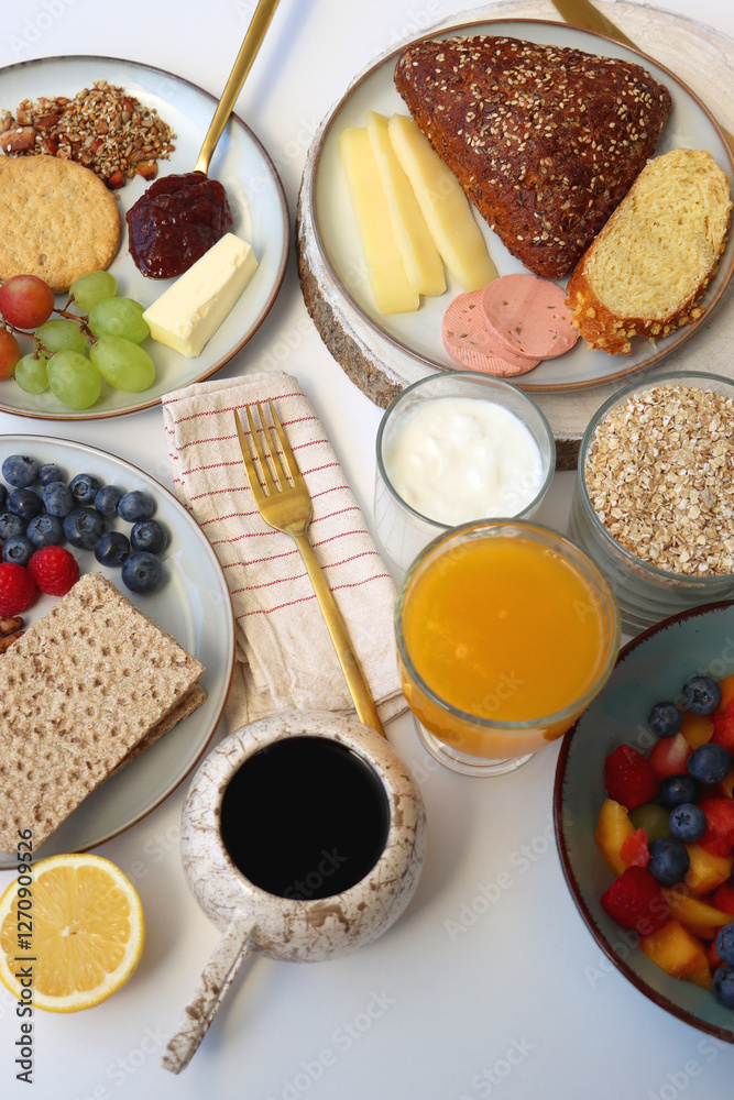 Assortment of various breakfast foods and drinks on the white table. Selective focus. Assortment of various breakfast foods and drinks on the white table. Selective focus.