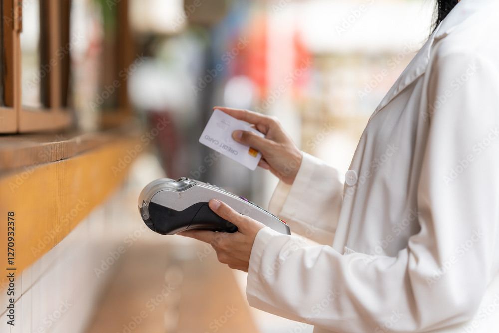 Contactless Payment with Card: A modern individual is depicted in a close-up, using a credit card for a seamless contactless payment transaction at a point-of-sale terminal.