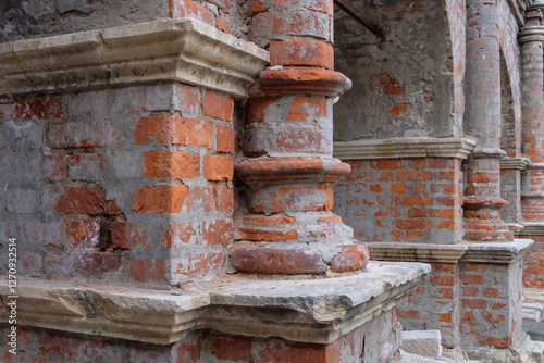 Fragment of ancient brickwork. Ancient red bricks in the wall.