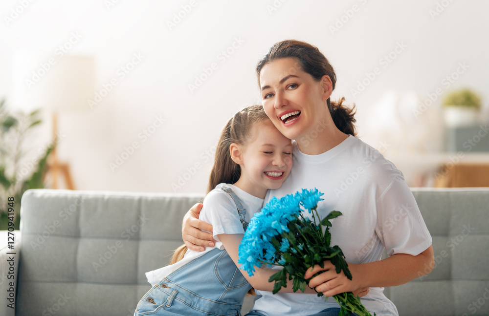 daughter is congratulating mom and giving her flowers daughter is congratulating mom and giving her flowers