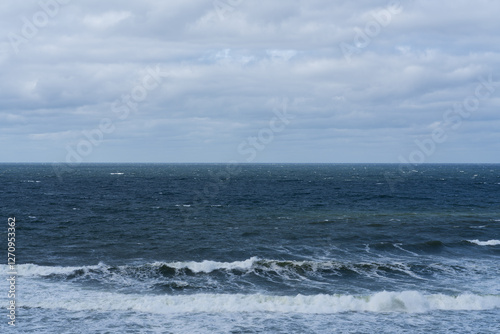 Fototapeta Naklejka Na Ścianę i Meble -  Sea in motion: a captivating view of the Baltic Sea with energetic waves and dramatic clouds in Estonia.