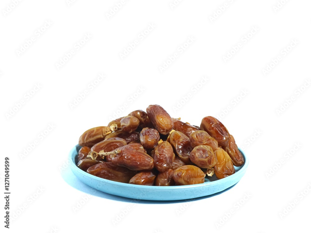 Pile of sweet dates on blue plate isolated on white background. Dried date fruit or dates, ramadan food Pile of sweet dates on blue plate isolated on white background. Dried date fruit or dates, ramadan food